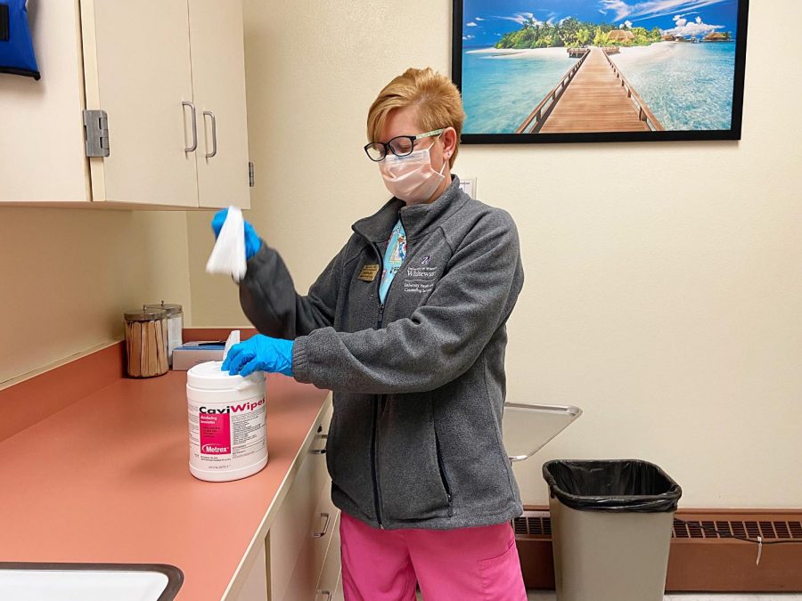 Cindy Millian, an Ambrose Medical Health Assistance Employee carefully sanitizes the room to get ready for its next patient, Thursday, April 1.