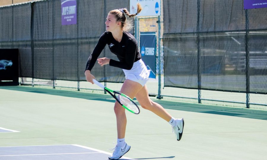 Senior Sabrina Palavra hits the ball back over to the UW-Lacrosse side while playing in a singles match during the WIAC women’s tennis championship.