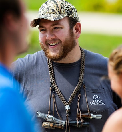Accounting major Jacob Weis, wearing duck calls with different sounds for different conditions, staffs a table for the Ducks Unlimited student organization. Student organizations of all kinds are on display at Involvement Day on Wyman Mall on the UW-Whitewater campus. 