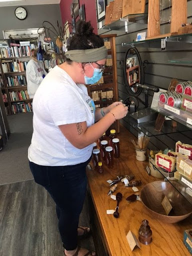 Junior elementary education major Anna Larsen takes a look at some products from Kettle Moraine Makers Doug and Deana Grall. 