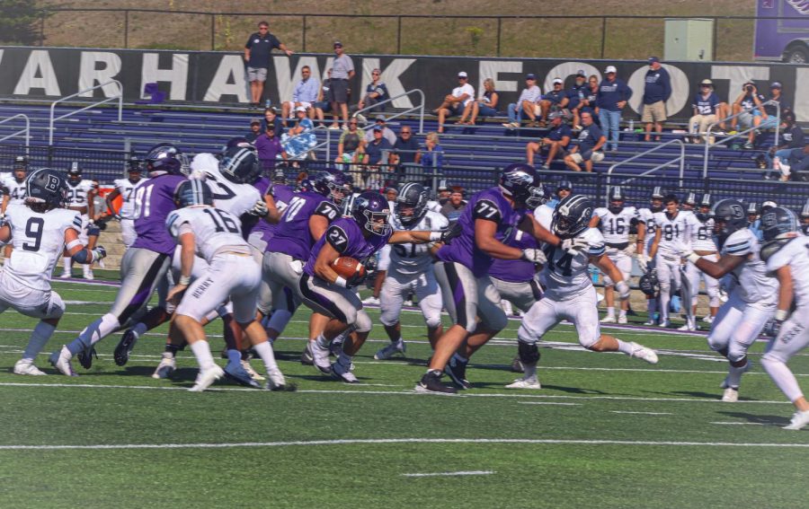 Junior Running back Ryan Ponick (27) escapes the crowd with the ball in Perkins Stadium during the game against Berry college, Saturday, Sept. 18, 2021.