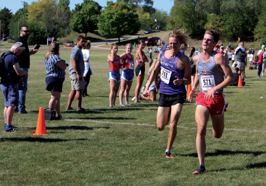 Whitewaters Freshman Chris Allen battles out a Washington U. competitor in the race to the finish line of the Tom Hoffman Invitational in Whitewater on Sept. 18, 2021.