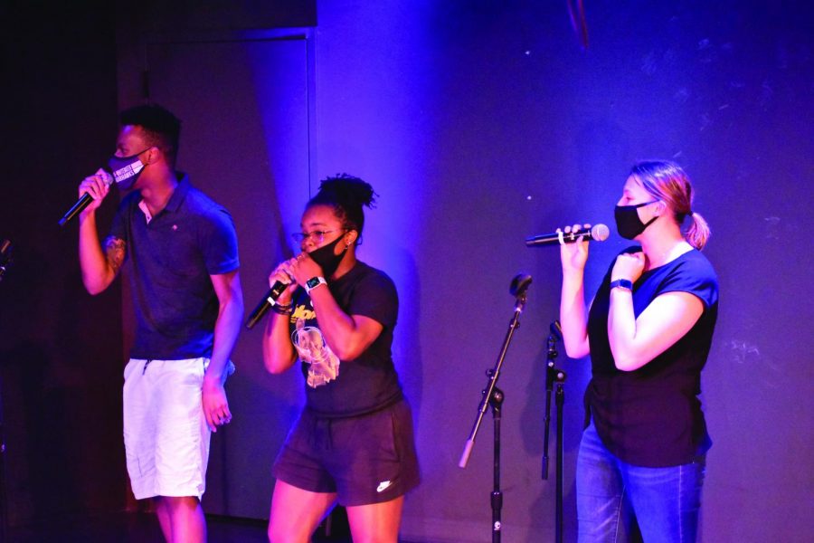 Dabe Okoli (Left), Maiya Tatum (Middle), and Peyton McLaughlin (Right) sing the song Super Bass for the other warhawks at karaoke night on 09/16/2021.