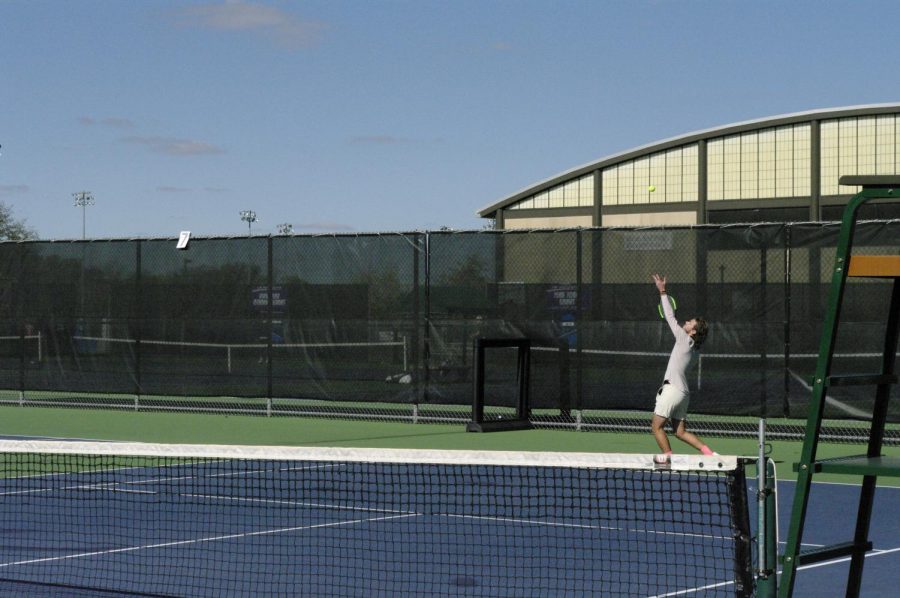 Kevin+McCann+tosses+the+tennis+ball+up+for+a+beautiful+serve+against+his+opponent+at+the+Wangerin+Tennis+Court+at+the+University+of+Wisconsin+Whitewater+during+the+club+tennis+invite.+October+23rd%2C+2021.