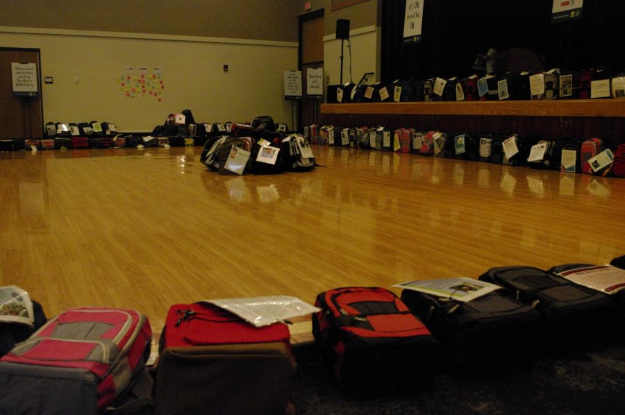 Backpacks organized in piles and lines in the Hamilton Room of the James R. Connor University Center, most with descriptions explaining the lives of those who claimed their own, Oct. 5, 2021. 