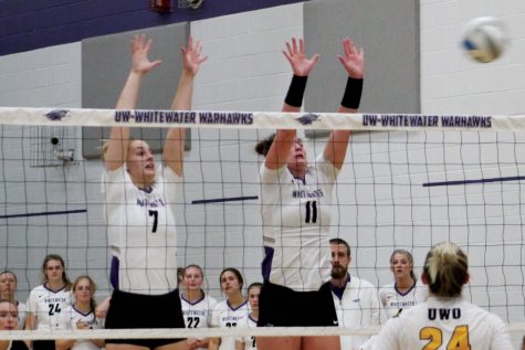 Senior middle hitter Morgan Wardall (7) and outside hitter Emma Aske (11) attempt to block a kill from UW-Oshkosh during their home game in the Williams Center on Sept. 15, 2021.