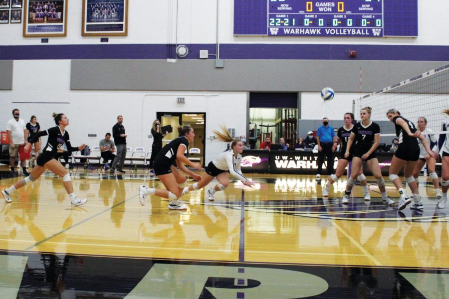 Junior libero Morgan Jensen dives to save the ball during the home game against the University of Dubuque on Oct. 13, 2021.