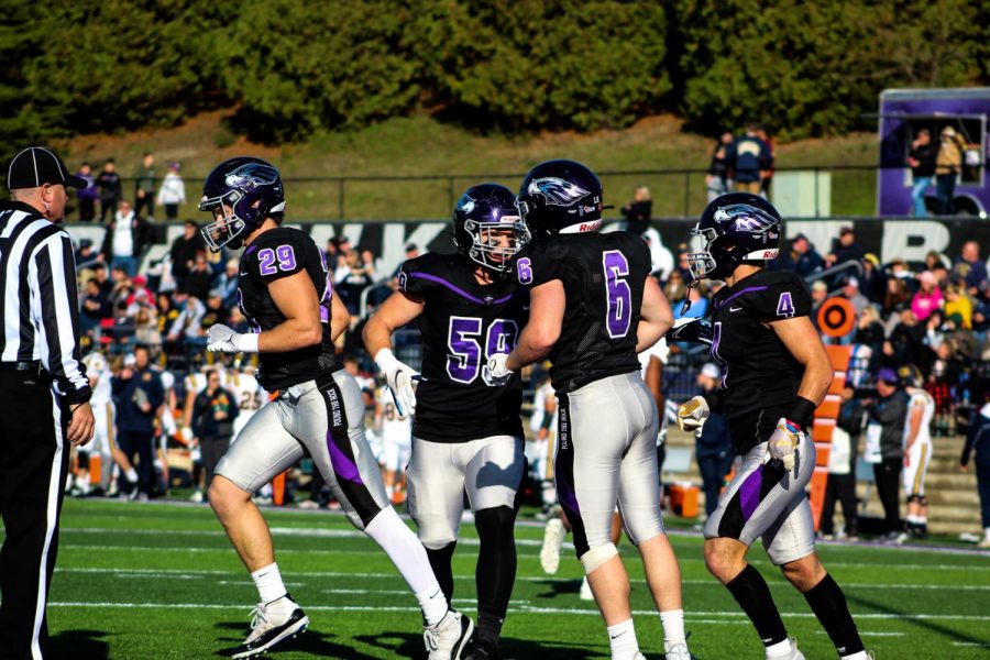 Players from the University of Wisconsin Whitewater Warhawks celebrating a touchdown together during the homecoming game on Saturday October, 30 2021. 
