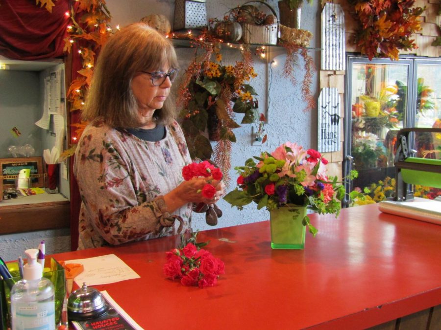 Local Floral Villa owner Pam Kraus prepares a flower bouquet at her shop on Oct. 21, 2021. 