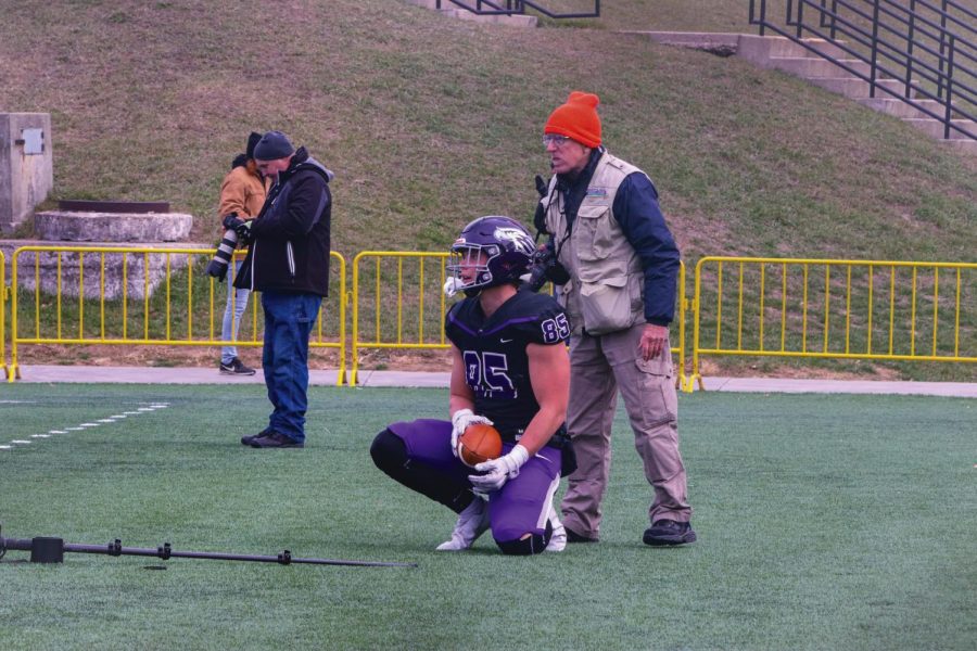 Senior tight end Michael Berentes (85) stumbles and scores with the football in the Warhawk end zone nearly running over camera equipment Saturday Nov. 27, 2021.