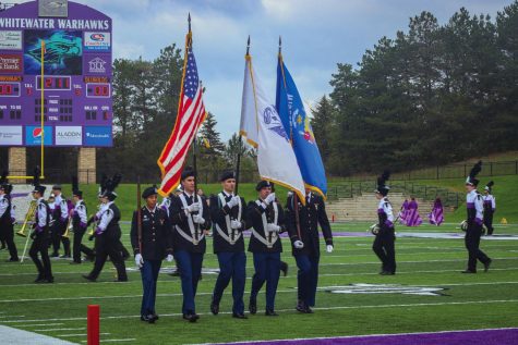 The National Flag and State flags are proudly waved by service members during the Warhawks Football game Saturday, Oct. 30, 2021.

