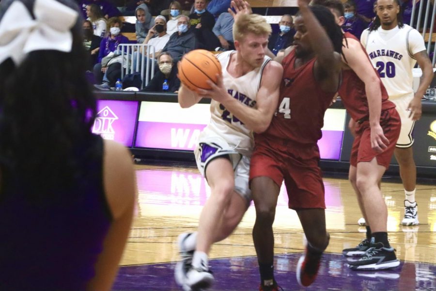 Junior forward Jack Brahm (24) pushes against the opposing team and makes his way towards the hoop, Fall 2021.