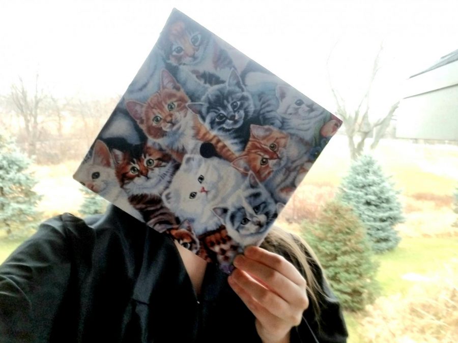 UWW graduate shows off a cat decorated cap
