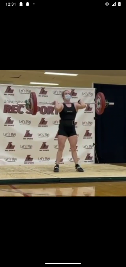 Robin WItt conducts a clean and jerk lift at a meet in La Crosse. 