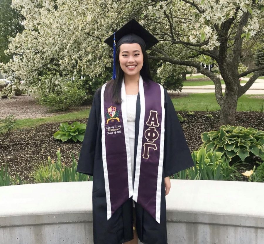 Spring 2021 Alpha Phi Gamma graduate Tiffany Xiong in her custom stoles from members of Alpha Phi Gamma. 