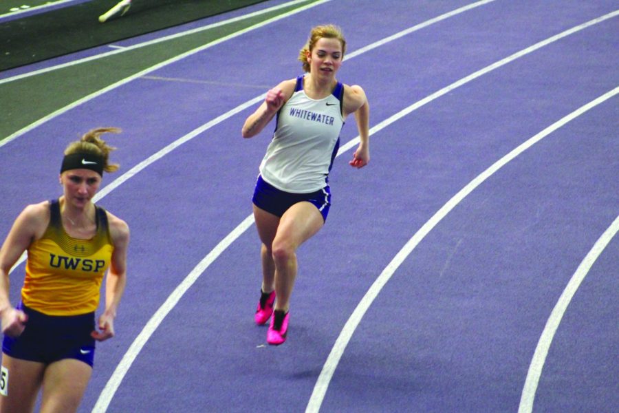 Junior Kylie Jacobs runs hard at the start of the seventh heat of the womens four hundred meter dash during the “Squig” Converse Invitational in Whitewater on Jan. 29, 2022.