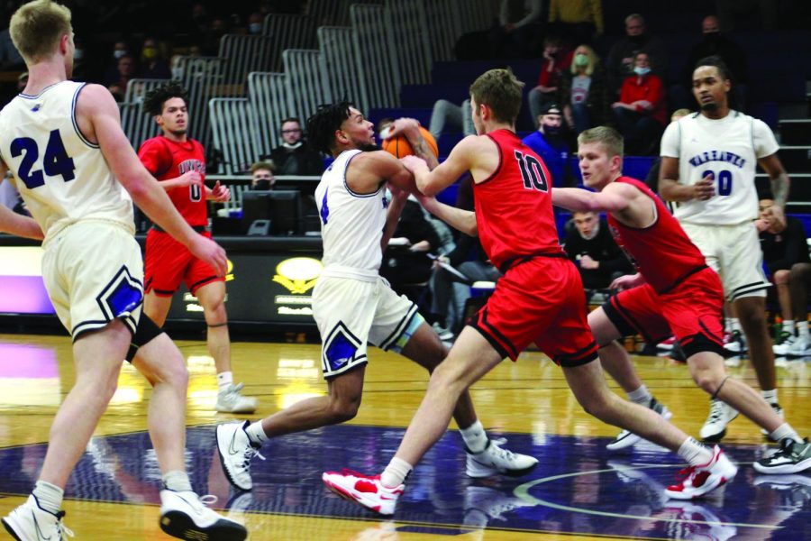 Freshman guard Derek Gray makes a drive toward the basket in hopes to cause a foul during their home game against the University of Wisconsin - River Falls Feb. 5, 2022.
