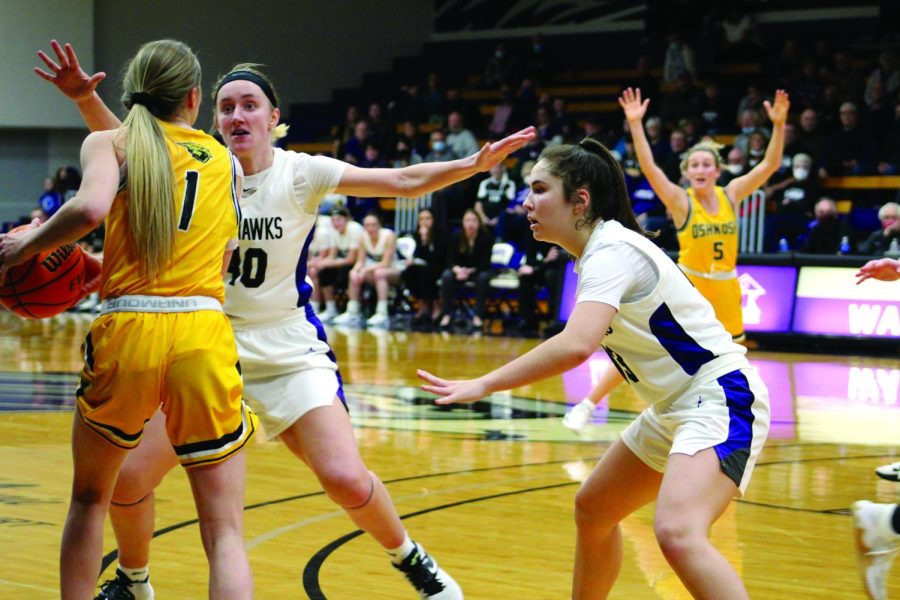Senior center Johanna Taylor and freshman guard Kacie Carollo team up to defend the hoop in their home game against the University of Wisconsin - Oshkosh Jan. 23, 2022