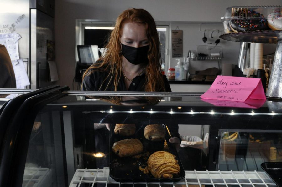 SweetSpot Co-Owner, Elena Gildemeister, helps her employees at the SweetSpot Bakehouse during a rush by gathering pastries for customers. February, 2022