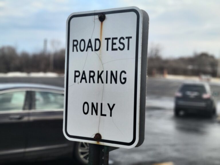 A sign marking where people taking road tests should park is seen outside the Wisconsin Division of Motor Vehicles Milwaukee-Central service center. (Photo: Edgar Mendez / Milwaukee Neighborhood News Service)