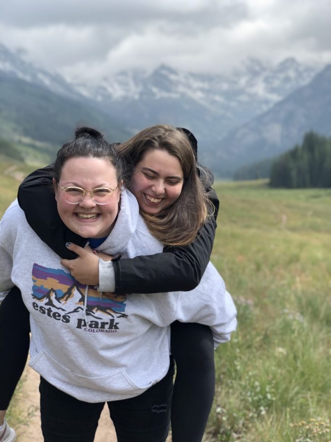 UW-W student Andi Britton gives her romantic partner, Mackenzie O’Connor, a piggy-back ride during a hike. 
