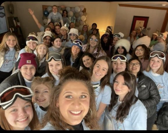 Alpha Gamma sorority members gather together for a winter selfie in the Alpha Gamma Greek house. 