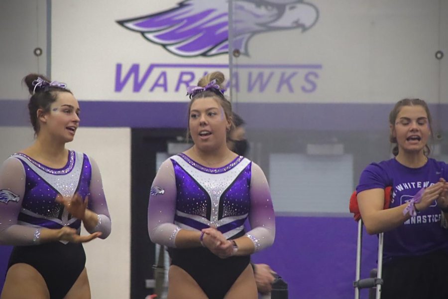 Freshman All Around Gracie Talley mingles with fellow teammates and warms up before the WIAC Gymnastics Championships start, Saturday evening, March 5, 2022.