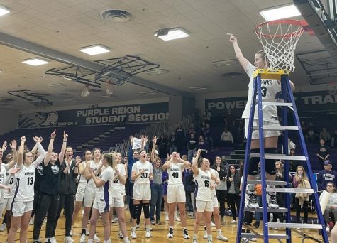 Cutting down nets: Junior forward Aleah Grundahl (33) cuts down the net after the game to celebrate the win.
