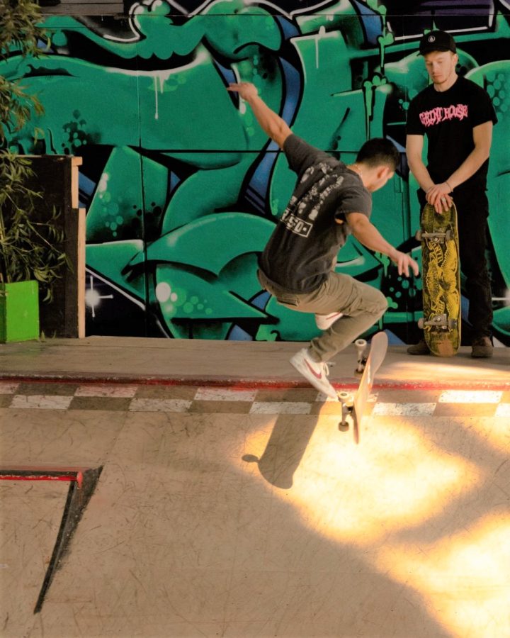 Cristian Diaz does a trick on his skateboard.