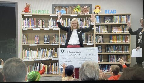State Treasurer Sarah Godlewski explains to the Lake Elementary kids what the check is for and what it will be used for.