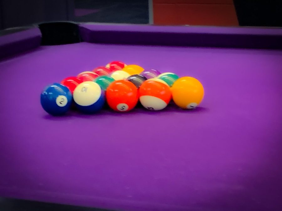 The first round of the tournament begins as the cue balls are set in the formation of a triangle, in UC-Warhawk Alley.