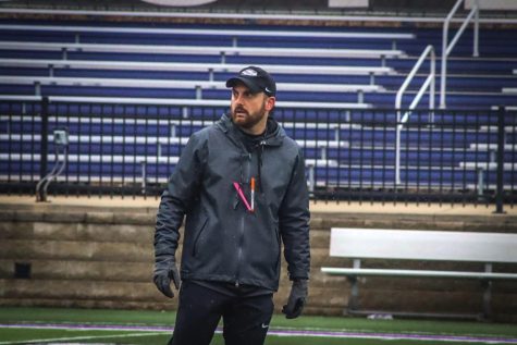 Offensive Coordinator for the Quarterbacks Nick Pesik observes the players warm ups during their practice in Perkins Stadium Friday afternoon April 8, 2022.