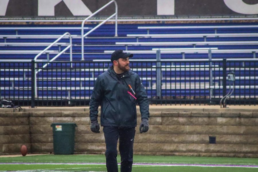 Nick Pesik the new offensive coordinator coach smiles as he looks on at the players during a practice Friday afternoon April 9, 2022.