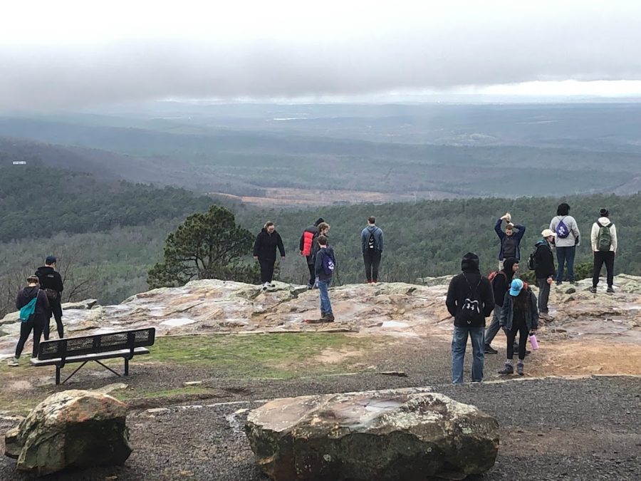 The Outdoor Adventure Club stands on a cliffs edge at Mount Nebo State Park.