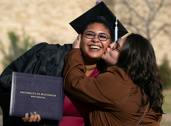 Brianna Johnson, left, a mathematics education major from Milwaukee, and her sister Anna Melamed celebrate outside the Williams Center after commencement on Saturday, Dec. 18, 2021. (UW-Whitewater photos/Craig Schreiner)