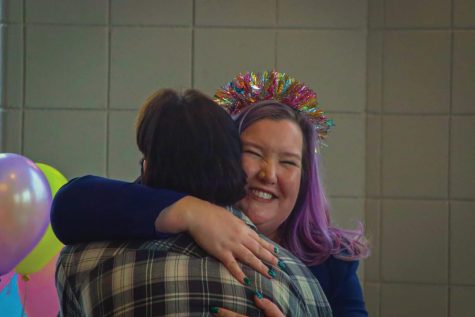 Professor of Women and Gender Studies Ashley Barnes-Gilbert (left) hugs and congratulates Miles Duckert, a senior who is taking a bachelor of science in social work(right) during the Rainbow Celebration of Excellence Thursday afternoon April 28, 2022.
