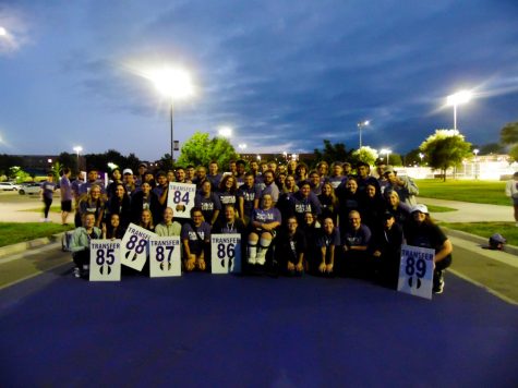 New Warhawks and Peer Mentors from team Transfer, collectively work together for the R U Purple? event, and celebrate on the painted road, for Paint-it-Purple at Warhawk Drive.