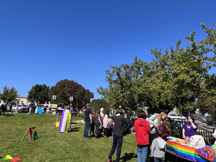 Attendees of the Whitewater Pride Rally gather around vendor tables Saturday, Oct. 1 in Cravath Lakefront Park. 