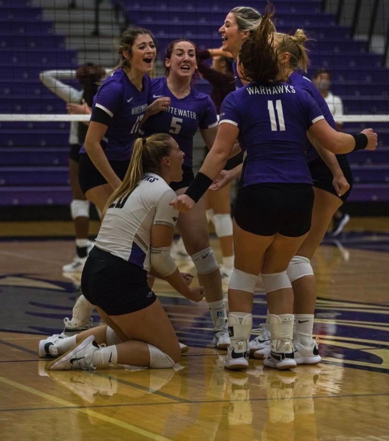 Jensen celebrates with her teammates after the Warhawks win a big point

