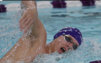Hunter Hayberger takes a breath of air as he breaks away from the water in a swimming race inside the Williams Center. Photo courtesy of Hunter Hayberger.
