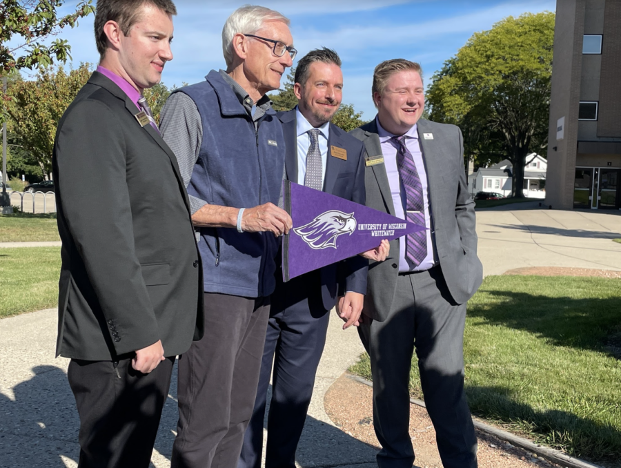 Wisconsin Governor Tony Evers accepts gifts of a UW-Whitewater banner and a stress ball cow, one of Evers’ favorite animals Thursday, Sept. 29 2022. He’s joined by graduate assistant Justin Wesolek (left), Legislative Liaison Jim Disrude (right) and Student Body President Will Hinz.