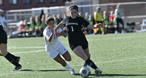 Sarah Clancy protects the ball from a defender during a game
