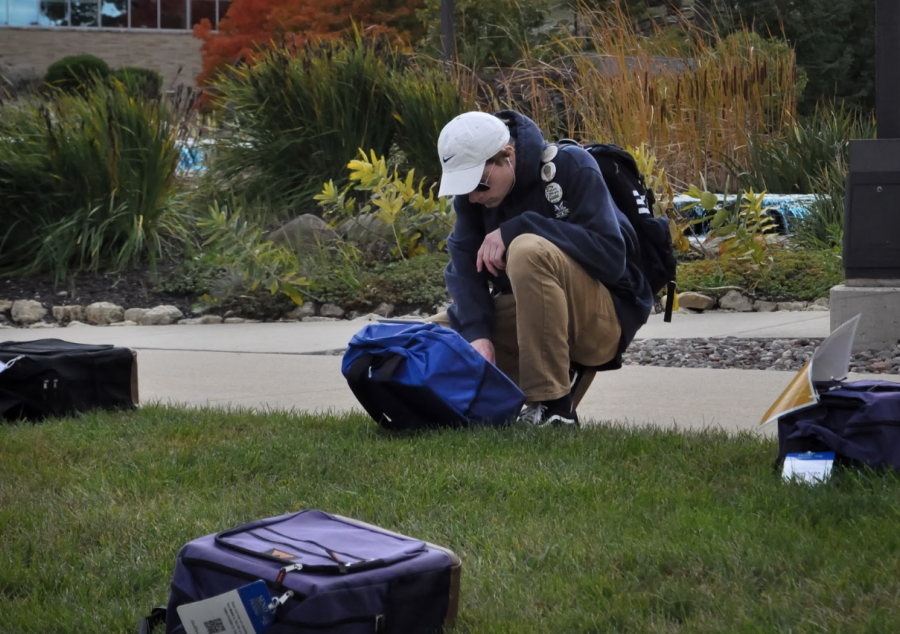 After a walk-through of the Send Silence Packing display, senior Chuck Leston stops to read a story of a student who lost their life to suicide. Approximately 1,000 backpacks lined the U.C. North Mall at the display.
