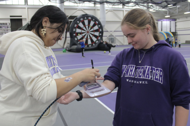 Elementary Education Major Lindsey Andeson receives an airbrush tattoo from Admissions employee Nikki Breu at Willie’s Fun Zone during Family Fest Oct. 14th, 2022. 