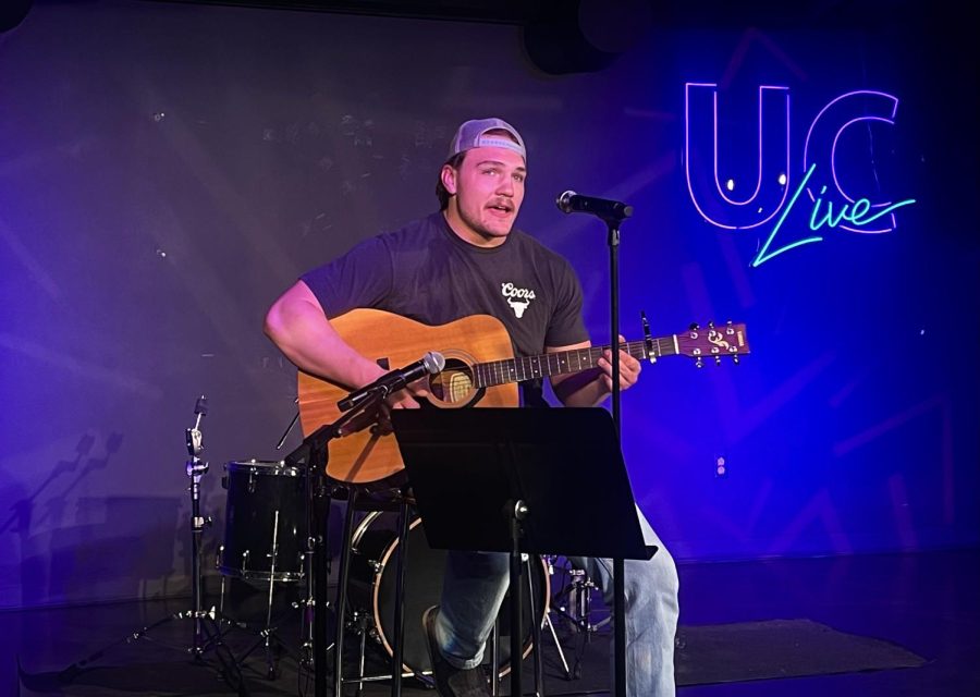 Senior Cadin Koeppel showcases his talents for the crowd at the UC on Thursdays open mic night in the Down Under, singing country songs and playing guitar