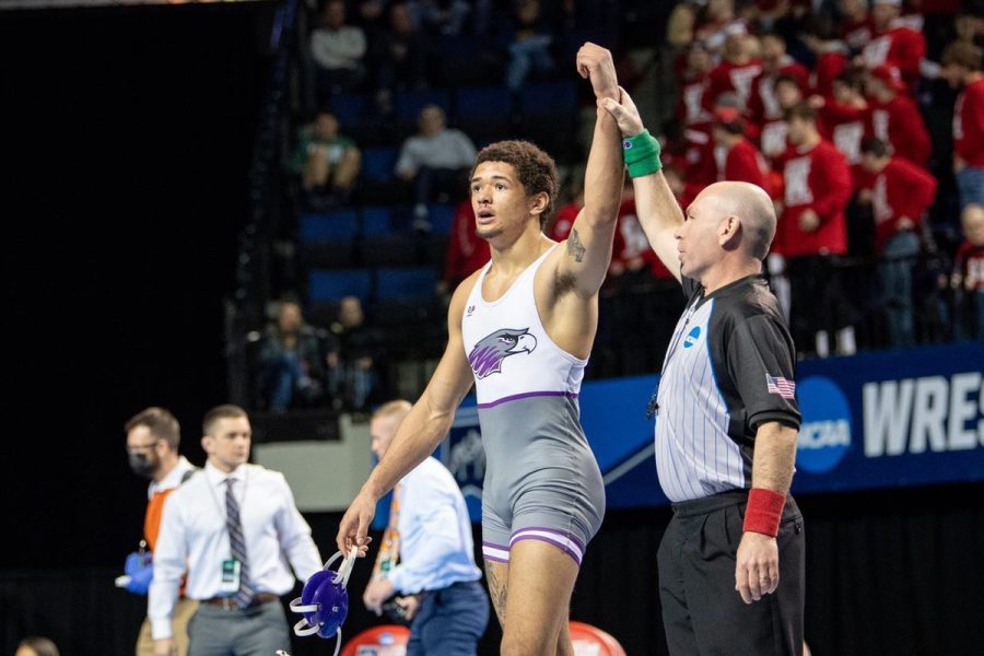 Jarrit Shinhoster’s fist is raised by an official to display his victory at the NCAA national tournament in Cedar Rapids, Iowa, March 12, 2022.
Photo Courtesy of Jarrit Shinhoster
