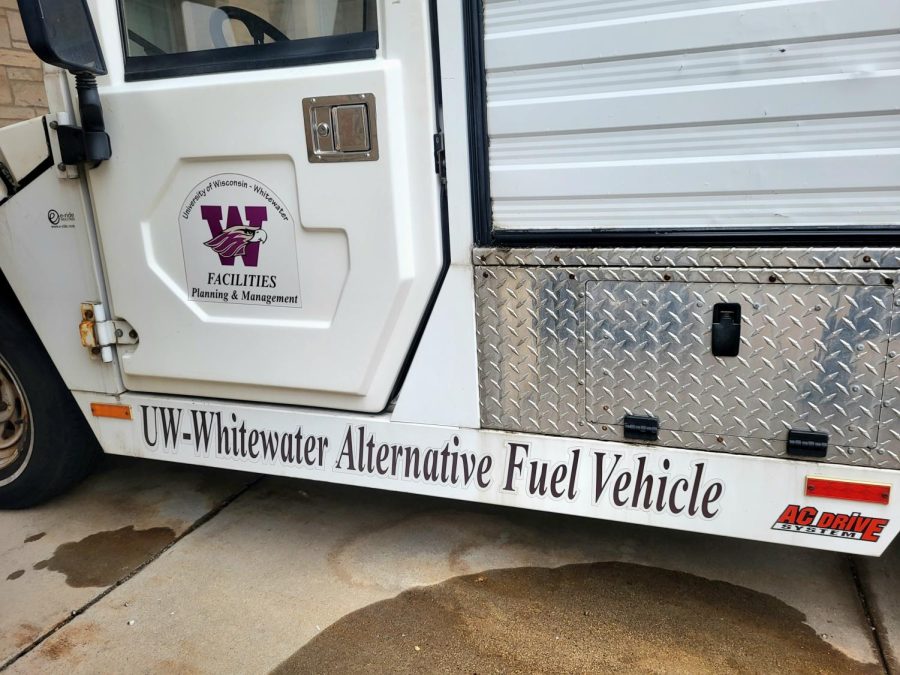 A UW-Whitewater electric powered vehicle sits outside the Anderson library. 