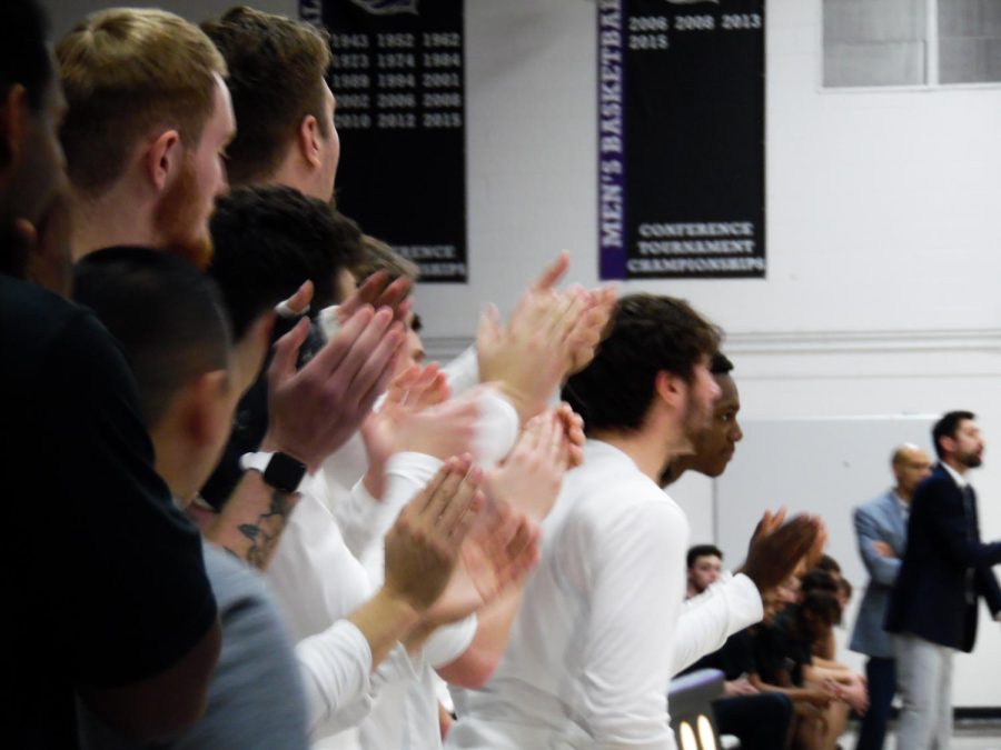 UW-Whitewater students, on the men’s basketball team, cheer as a teammate makes a basket at the game versus North Central College, at the Williams Center.
