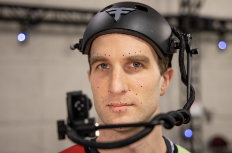 Alumni Tyler King demonstrates a newly designed facial capture helmet with Faceware Tech.