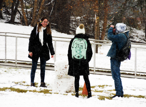 UW-Whitewater students build a snowman in between classes by the Center of the Arts.
